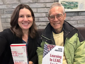 Katie and Isao Yoshino with Learning to Lead books in English and Japanese