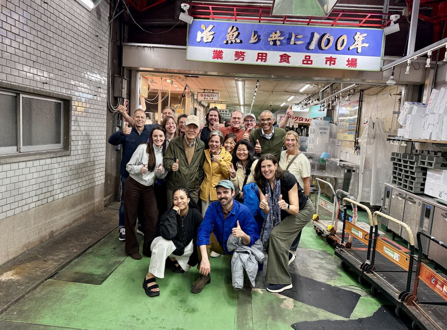 Participants learning about Japanese craftsmanship during a sake brewery visit in Japan.